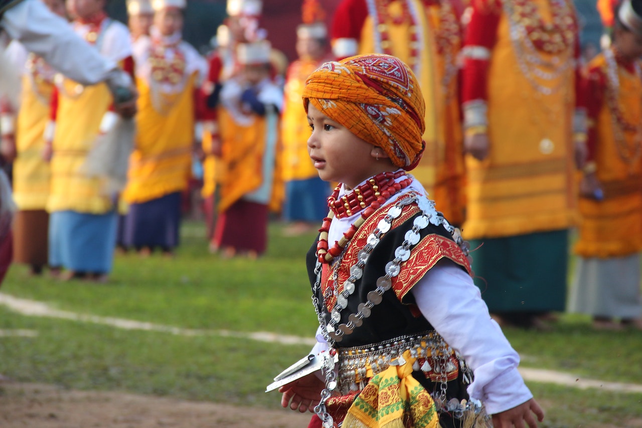 A Boy Wearing Traditional Wear in a Parade · Free Stock Photo